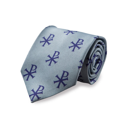 Blue Chi-Rho necktie in silver grey with navy blue repeating Chi-Rho Christogram pattern, rolled product shot on white background