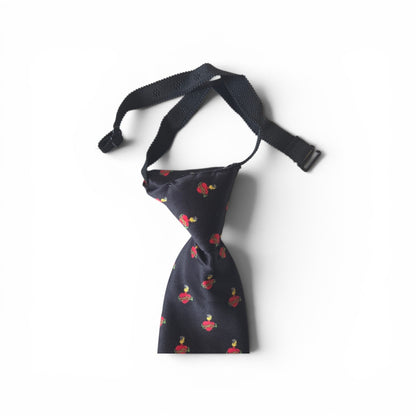 Boys Sacred Heart of Jesus pretied necktie in navy blue with repeating red Sacred Heart pattern, showing adjustable neck strap and buckle closure on white background