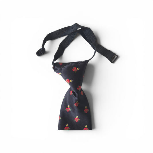 Boys Sacred Heart of Jesus pretied necktie in navy blue with repeating red Sacred Heart pattern, showing adjustable neck strap and buckle closure on white background