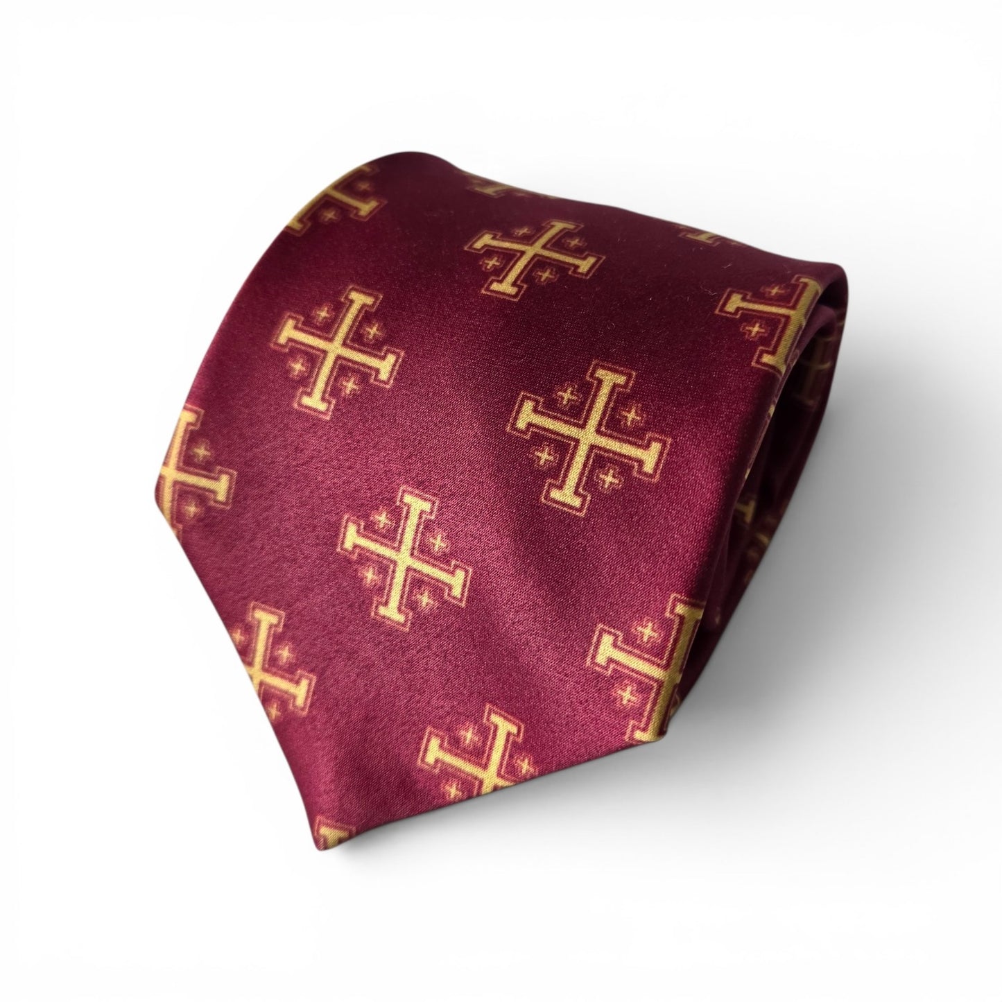 Gold Jerusalem Cross necktie in maroon with repeating gold crusader cross pattern, rolled product shot on white background