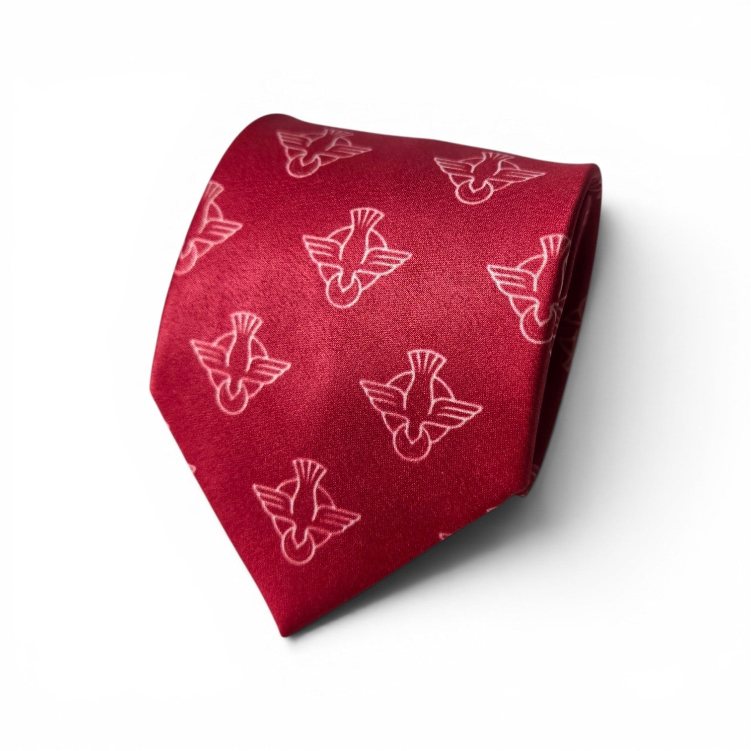 Holy Spirit necktie in red with repeating pink descending dove symbol pattern, rolled product shot on white background