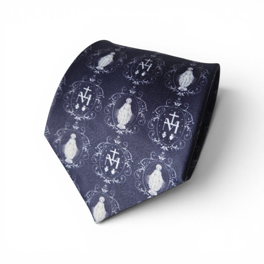 Miraculous Medal necktie in navy blue with repeating white Our Lady and Marian monogram medallion pattern, rolled product shot on white background