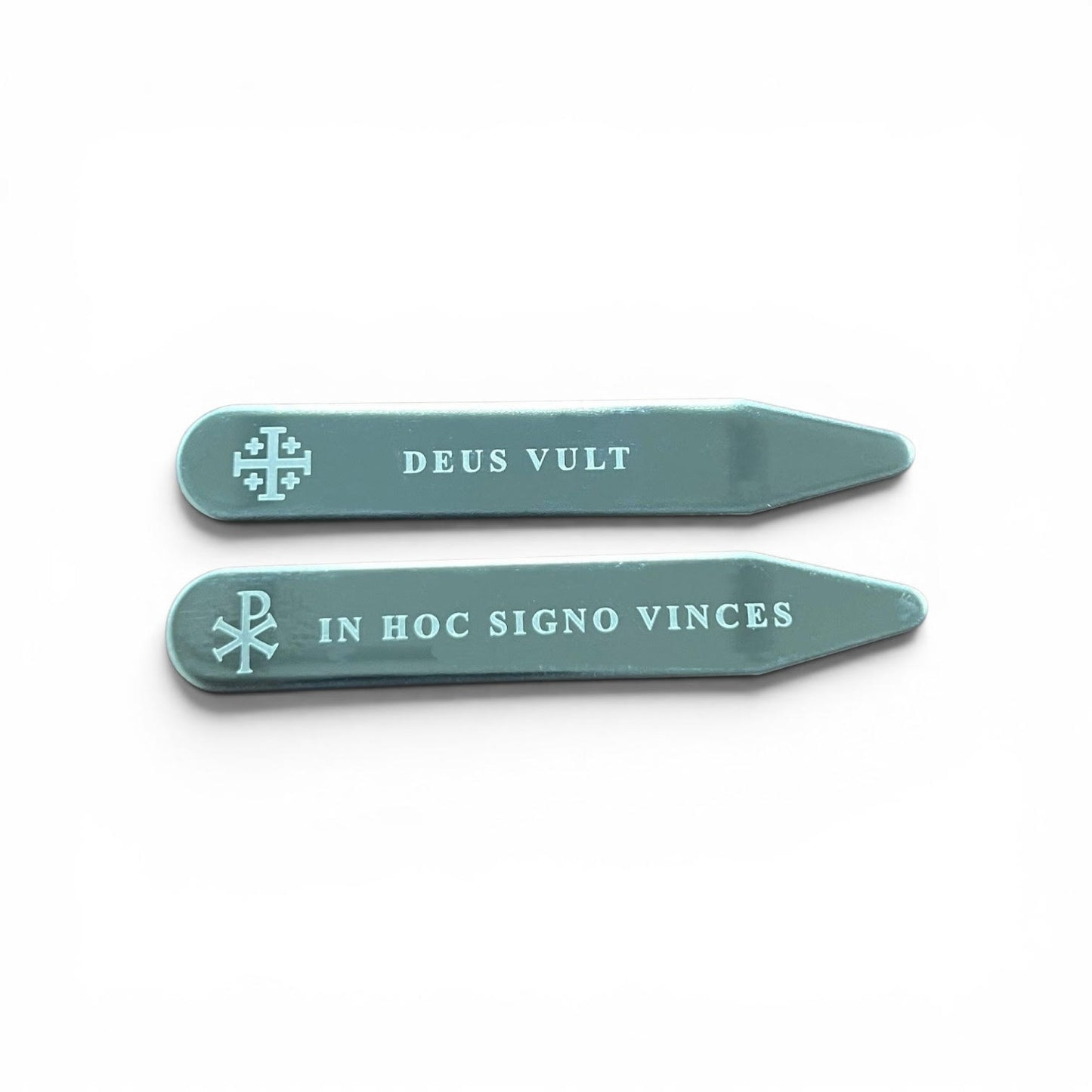 Set of two silver engraved collar stays featuring Chi-Rho with In Hoc Signo Vinces and Jerusalem Cross with Deus Vult inscriptions, flat lay on white background